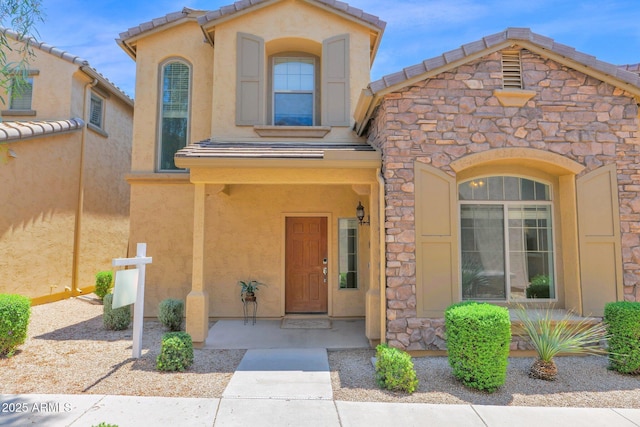3977 E Cat Balue Dr, Phoenix, AZ 85050 - mediterranean / spanish-style house featuring stucco siding and stone siding