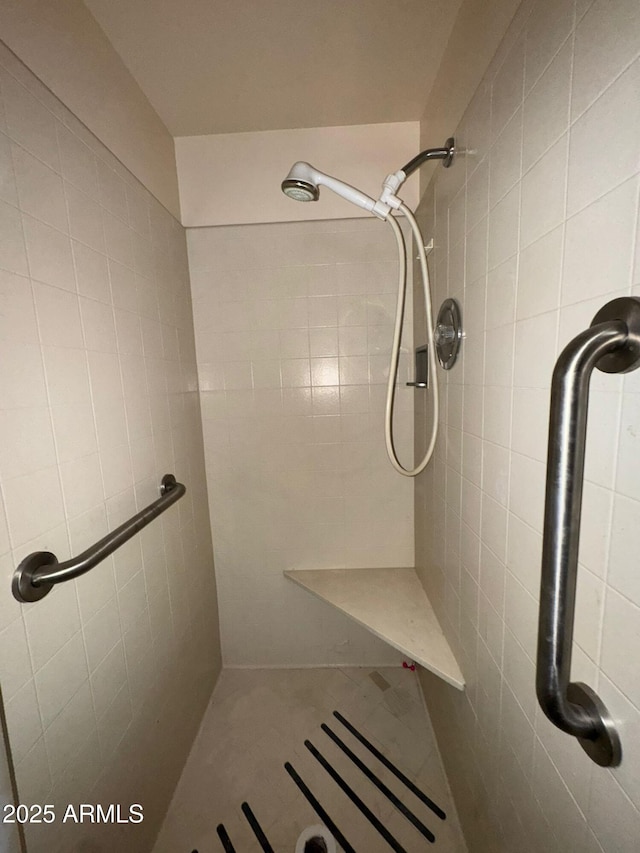 bathroom with tiled shower