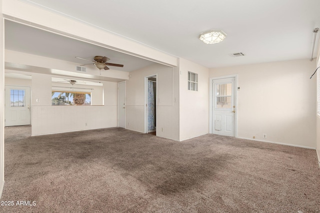 unfurnished room featuring ceiling fan and carpet flooring