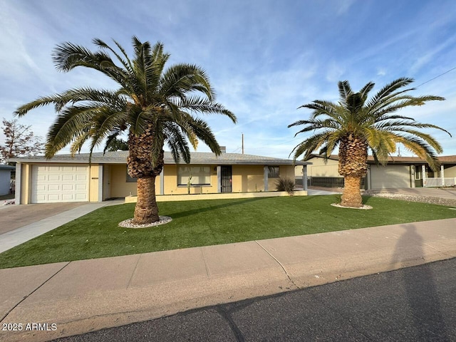 view of front of house with a garage and a front lawn