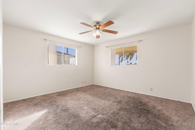 empty room featuring carpet floors and ceiling fan