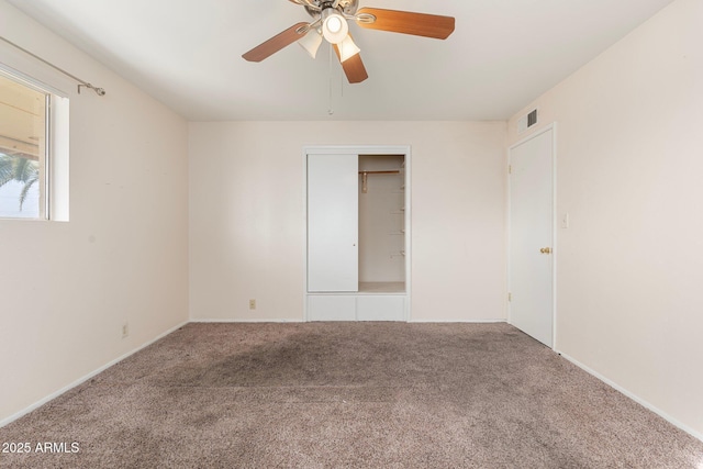 unfurnished bedroom with ceiling fan, a closet, and carpet