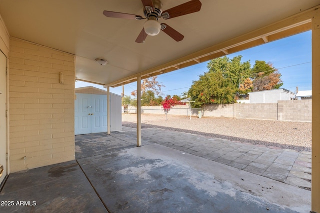 view of patio / terrace featuring ceiling fan and a storage shed