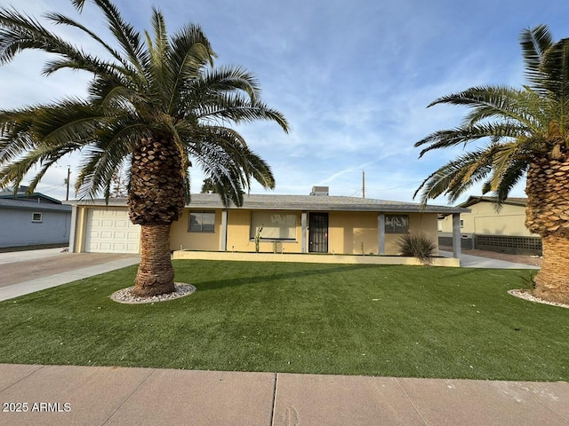 view of front of house featuring a garage and a front lawn