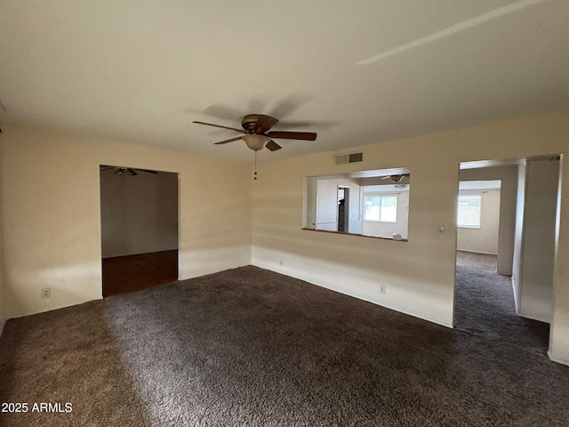 carpeted spare room featuring ceiling fan