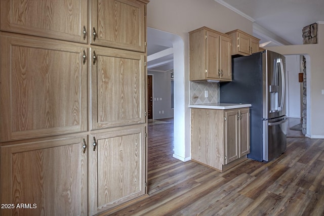 kitchen featuring backsplash, crown molding, dark wood-type flooring, stainless steel fridge with ice dispenser, and light brown cabinetry