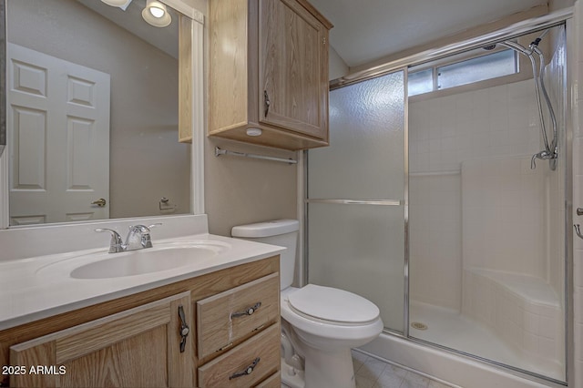 bathroom featuring an enclosed shower, vanity, and toilet