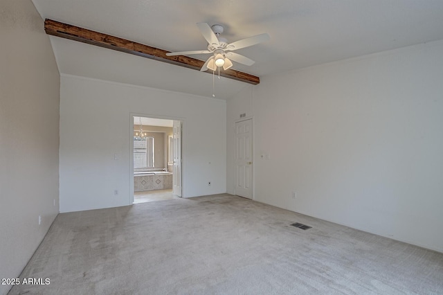 carpeted spare room featuring ceiling fan with notable chandelier and lofted ceiling with beams