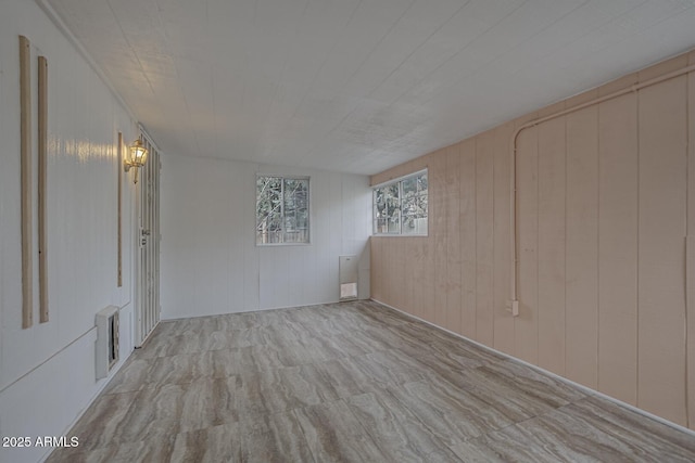 spare room with wood walls