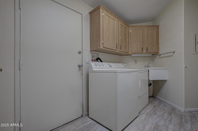 clothes washing area featuring washer / dryer and cabinets