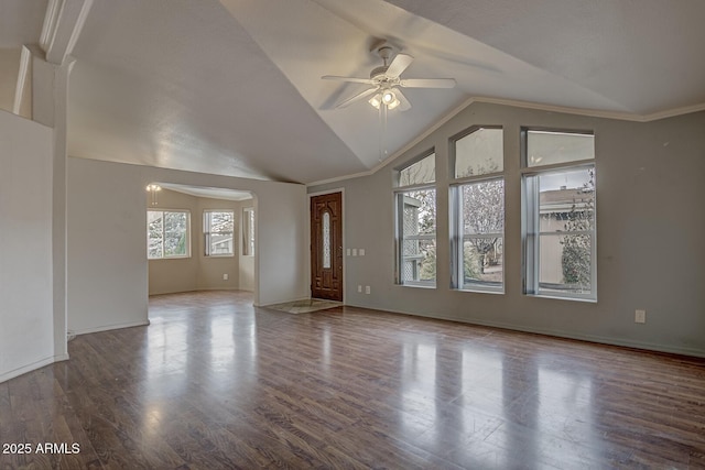 unfurnished living room featuring ceiling fan, wood-type flooring, crown molding, and lofted ceiling