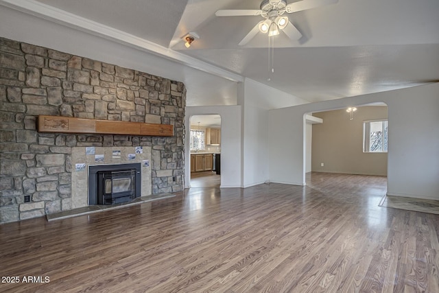 unfurnished living room featuring ceiling fan, plenty of natural light, hardwood / wood-style floors, and vaulted ceiling