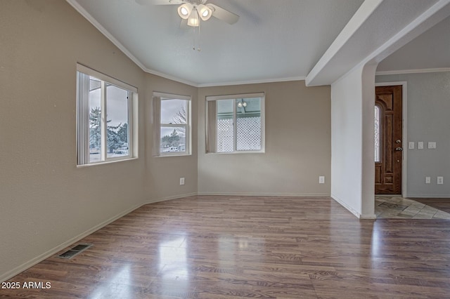 empty room with ceiling fan, ornamental molding, and hardwood / wood-style flooring