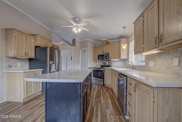 kitchen with hanging light fixtures, sink, light brown cabinets, and stainless steel appliances