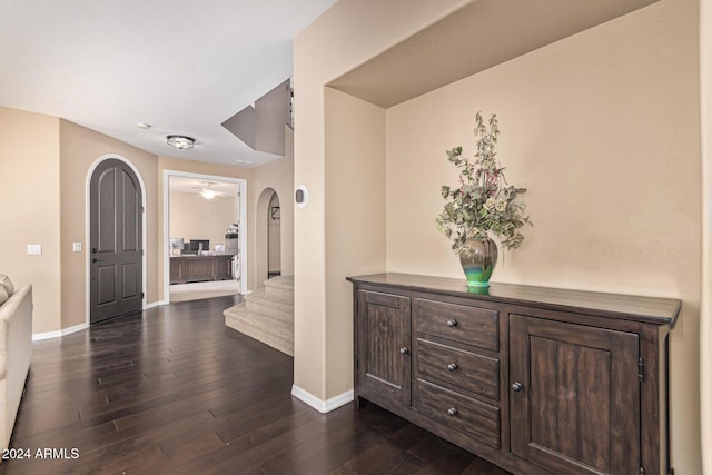 3964 E Hummingbird Ln, Phoenix, AZ 85050 - hall featuring dark wood finished floors, baseboards, stairway, and arched walkways