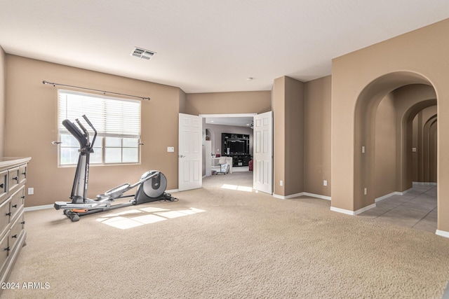 3964 E Hummingbird Ln, Phoenix, AZ 85050 - exercise area with carpet floors, baseboards, and arched walkways