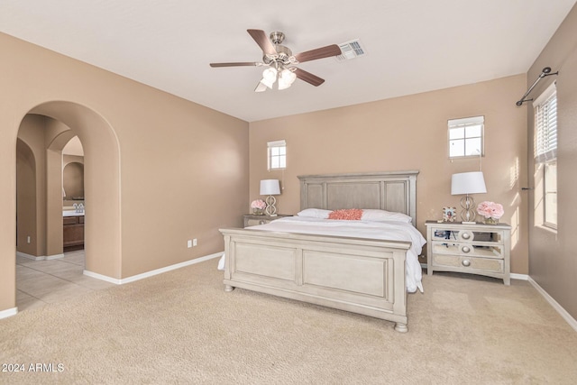 3964 E Hummingbird Ln, Phoenix, AZ 85050 - bedroom featuring light carpet, arched walkways, baseboards, and ceiling fan