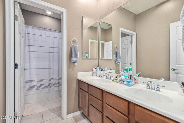 3964 E Hummingbird Ln, Phoenix, AZ 85050 - bathroom featuring double vanity, tile patterned flooring, and shower / bath combo with shower curtain