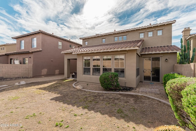 3964 E Hummingbird Ln, Phoenix, AZ 85050 - rear view of property with stucco siding, fence, and a tiled roof