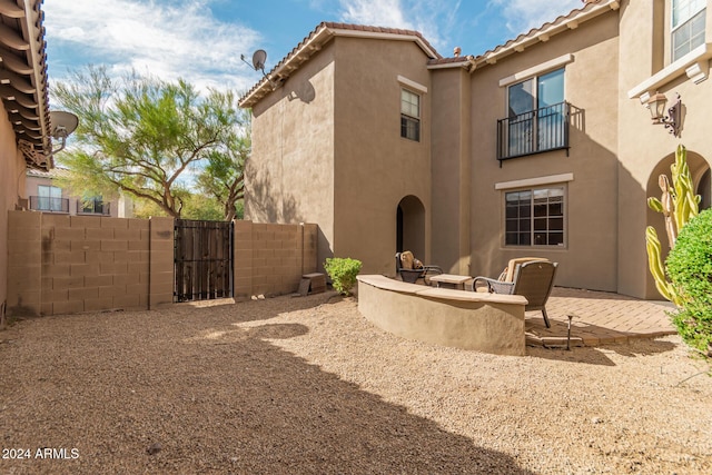 3964 E Hummingbird Ln, Phoenix, AZ 85050 - back of house featuring stucco siding, fence, a gate, and a patio