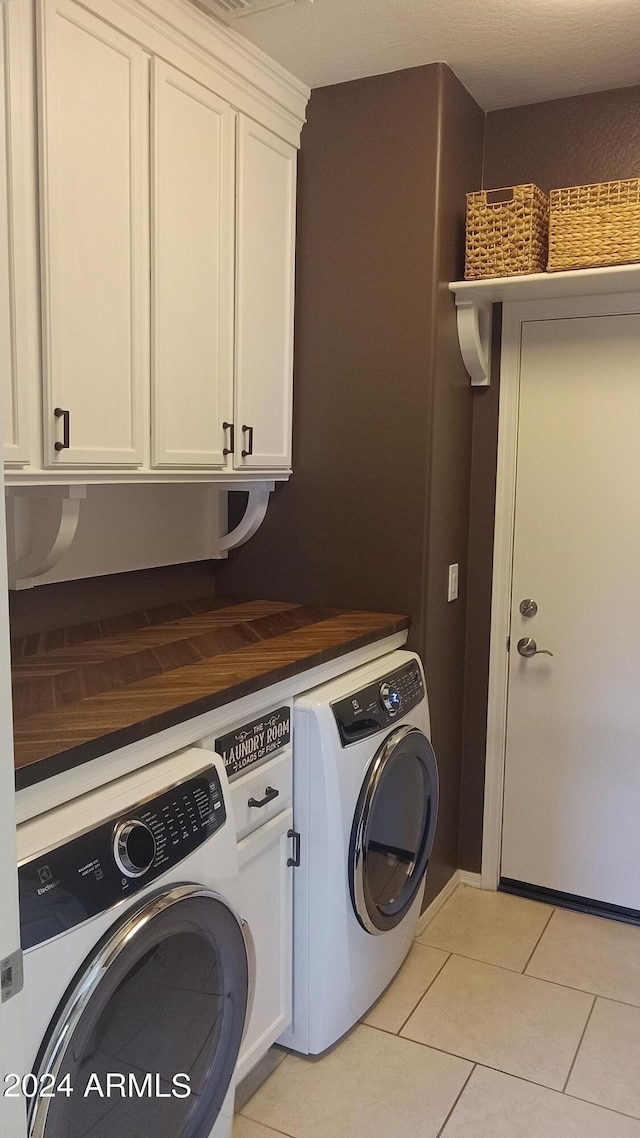 41318 N Belfair Way, Anthem, AZ 85086 - laundry room featuring washing machine and clothes dryer, cabinet space, and light tile patterned flooring