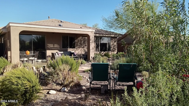 41318 N Belfair Way, Anthem, AZ 85086 - rear view of house featuring stucco siding, an outdoor living space, and a patio