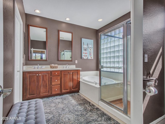 41318 N Belfair Way, Anthem, AZ 85086 - bathroom with double vanity, a garden tub, recessed lighting, a shower with shower door, and a textured wall