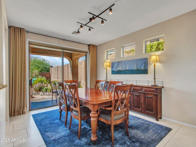 41318 N Belfair Way, Anthem, AZ 85086 - dining space with light tile patterned floors, track lighting, and baseboards