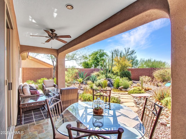 41318 N Belfair Way, Anthem, AZ 85086 - fenced backyard with ceiling fan, a patio area, and outdoor dining area