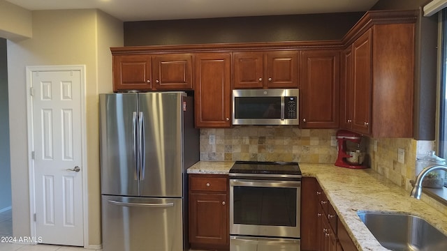 41318 N Belfair Way, Anthem, AZ 85086 - kitchen featuring stainless steel appliances, a sink, backsplash, and light stone counters