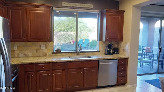 41318 N Belfair Way, Anthem, AZ 85086 - kitchen with stainless steel appliances, a sink, light tile patterned floors, decorative backsplash, and plenty of natural light