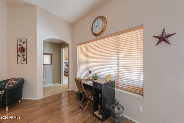 dining room with hardwood / wood-style floors and vaulted ceiling