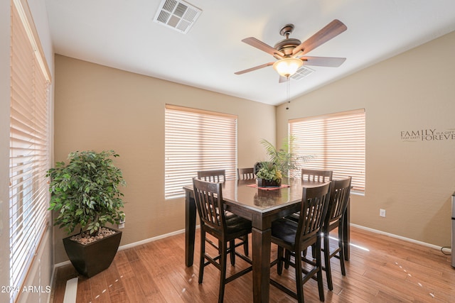 dining area featuring vaulted ceiling, light hardwood / wood-style flooring, and ceiling fan