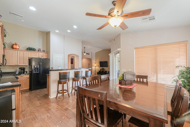 dining area with light hardwood / wood-style floors and ceiling fan