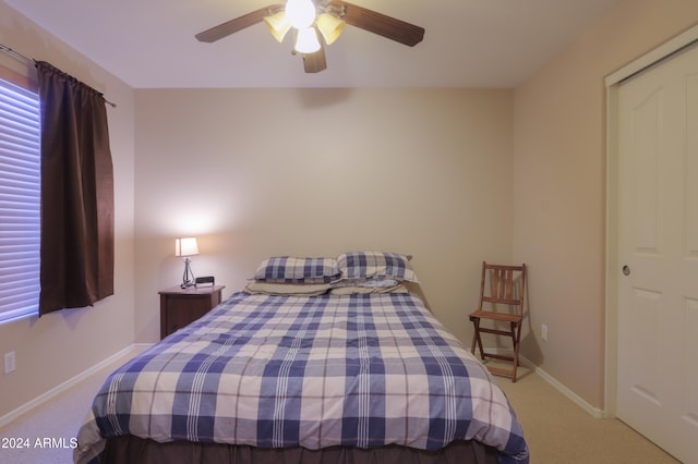 carpeted bedroom featuring a closet and ceiling fan