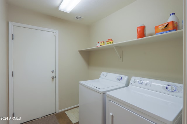 laundry room featuring light hardwood / wood-style floors and washer and dryer