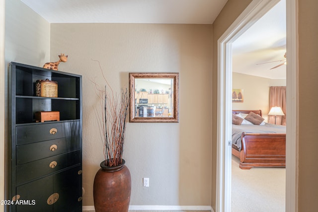 hallway with carpet and vaulted ceiling