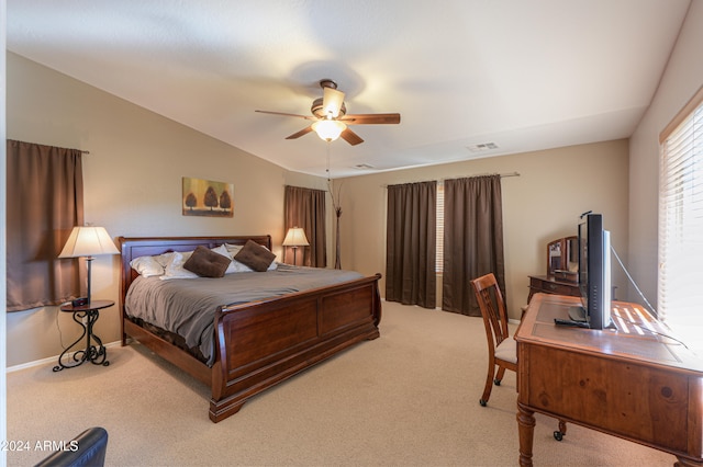 carpeted bedroom featuring ceiling fan and vaulted ceiling