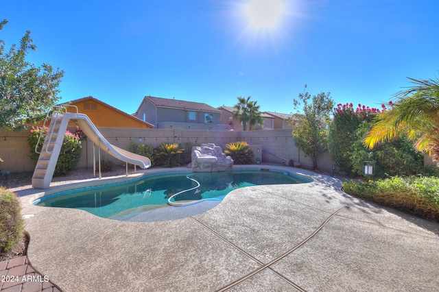 view of pool featuring a patio and a water slide