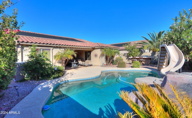 view of pool featuring a patio and a water slide