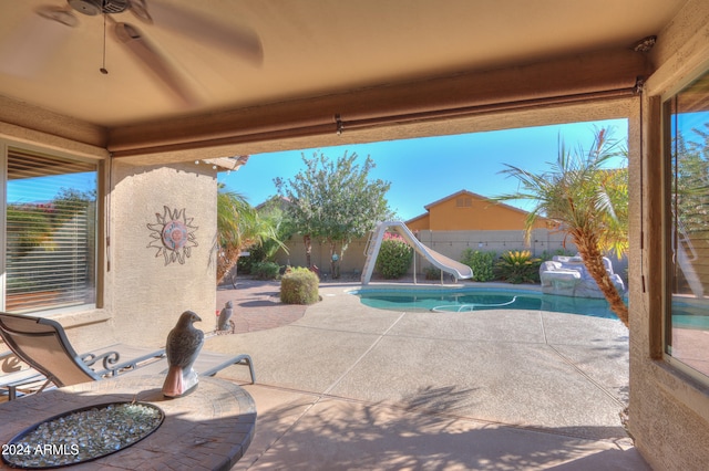 view of patio with a fenced in pool and ceiling fan