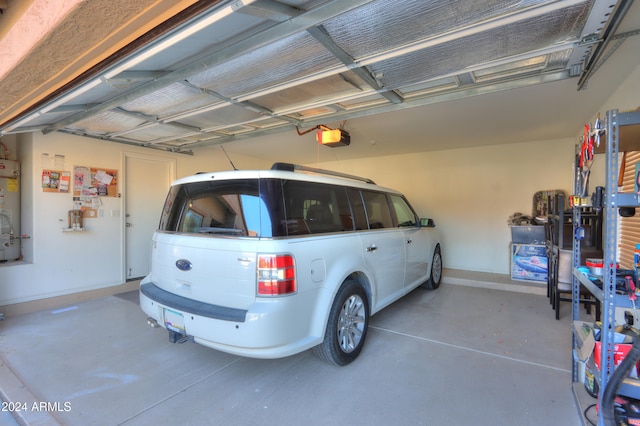 garage with a garage door opener and secured water heater