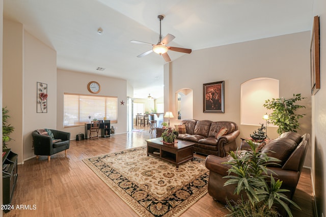 living room featuring hardwood / wood-style floors and ceiling fan