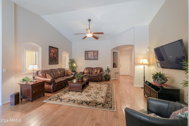 living room featuring light hardwood / wood-style flooring, high vaulted ceiling, and ceiling fan