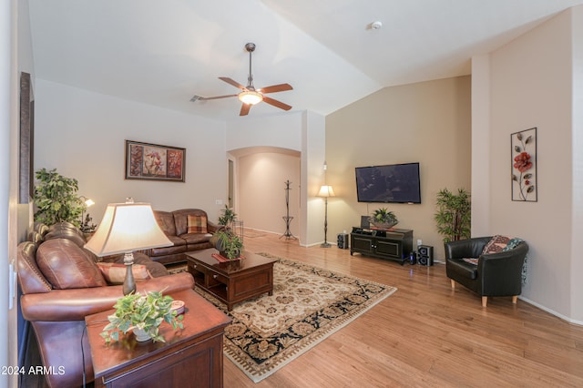 living room with vaulted ceiling, light hardwood / wood-style flooring, and ceiling fan