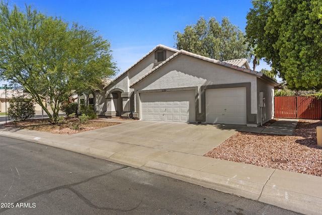 1135 W Sea Fog Dr, Gilbert, AZ 85233 - ranch-style house featuring a garage, stucco siding, a tiled roof, and concrete driveway