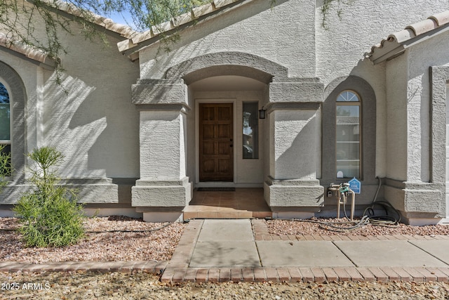1135 W Sea Fog Dr, Gilbert, AZ 85233 - view of exterior entry featuring stucco siding and a tiled roof