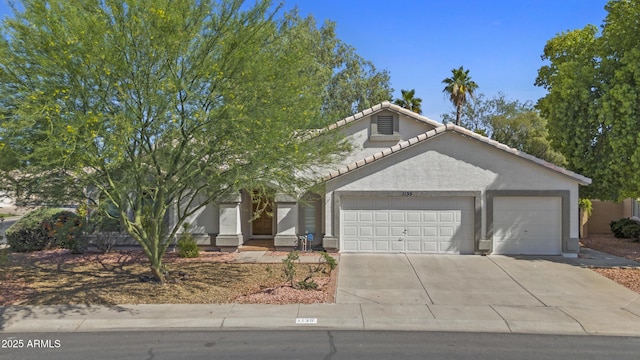 1135 W Sea Fog Dr, Gilbert, AZ 85233 - view of front of house featuring an attached garage, concrete driveway, a tile roof, and stucco siding