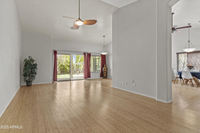 1135 W Sea Fog Dr, Gilbert, AZ 85233 - unfurnished living room featuring a ceiling fan, wood finished floors, and arched walkways