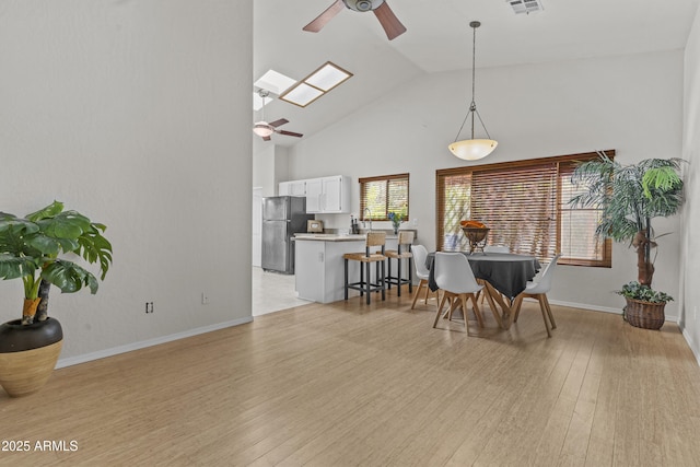 1135 W Sea Fog Dr, Gilbert, AZ 85233 - dining space featuring ceiling fan, high vaulted ceiling, and light wood-style floors